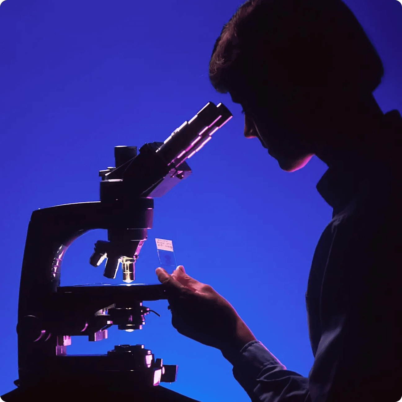Scientist working with microscope in laboratory - AI-powered biotech research